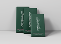 Three dark green rectangular chocolate boxes arranged in a fan shape on a light gray surface against a light gray background. The front box is labeled 'annueli' in white script, with 'DARK + MORELLO CHERRY' and 'Belgian Chocolate' printed below.